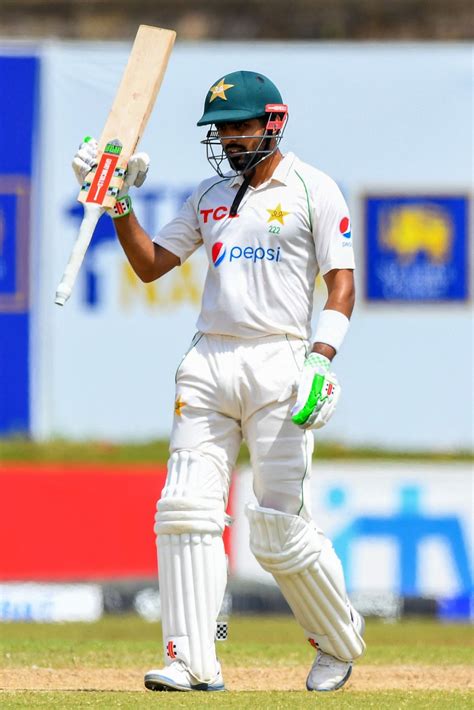 Babar Azam raises his bat after completing his 22nd Test half-century ...