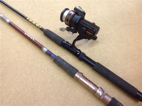 Lot Detail - TWO FISHING POLES AND A REEL