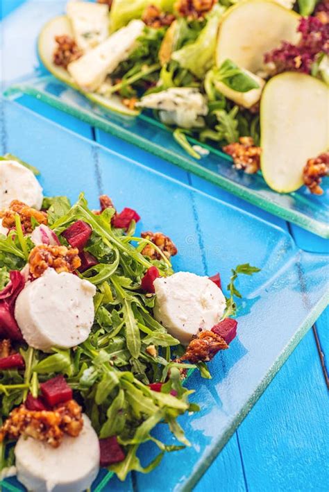 Fresh Mix Vegetable Salads On Glass Plate On Blue Wooden Background ...