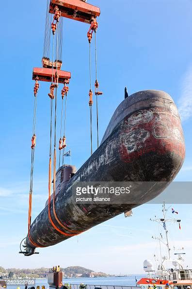 The submarine U17 is loaded onto a floating pontoon from the dry dock ...