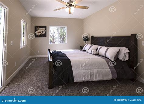 Master Bedroom with Dark Carpet and Bed Made San Diego California Stock ...