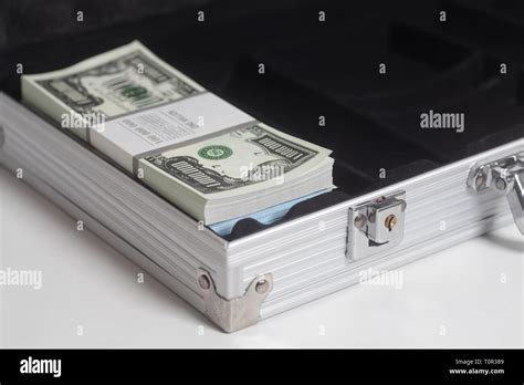 Open suitcase with one million dollars bills with tape on white ...