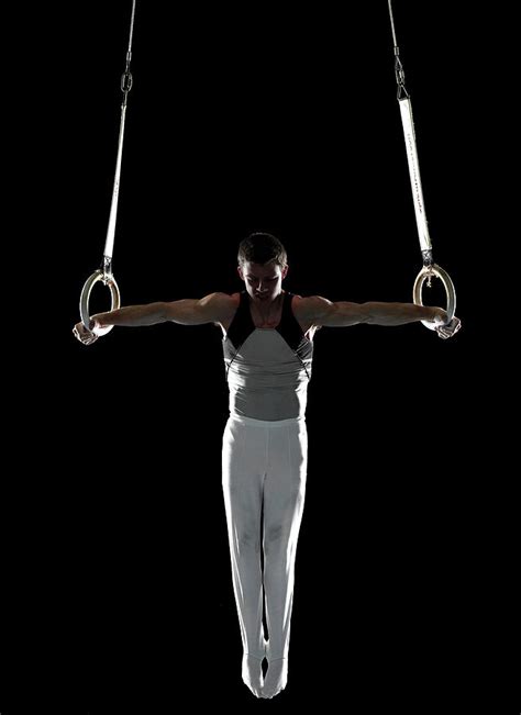 Male Gymnast Performing Iron Cross On by International Rescue