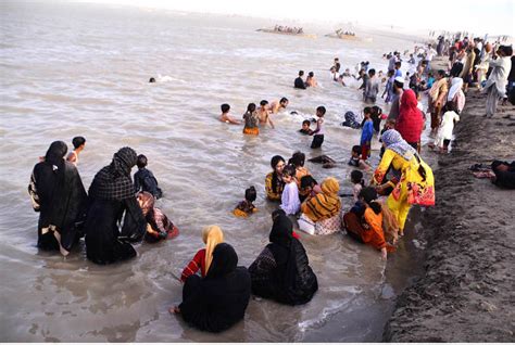 A view of large numbers of families with their children swimming and ...