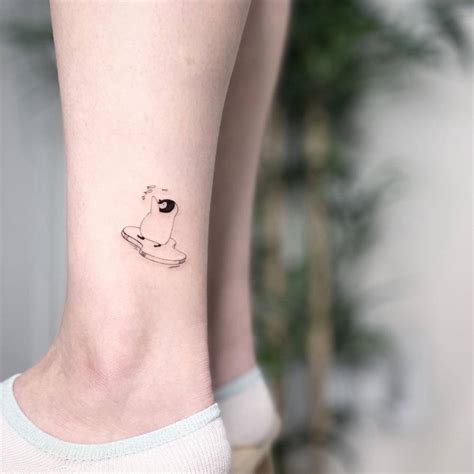 Tiny penguin tattoo on ankle