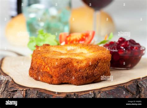 breaded camembert with salad on wood Stock Photo - Alamy