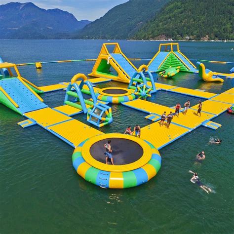 an inflatable water park with people swimming and playing on the water ...