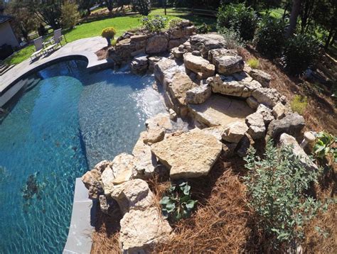 Natural Stone Outdoor Living Area | Stone pool, Pool waterfall ...