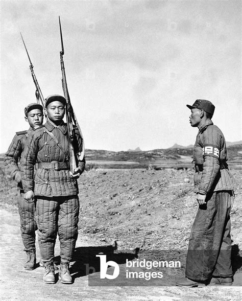 Image of Korea: A North Korean military policeman with two North Korean