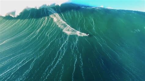 Drone video of surfer riding giant wave in Nazaré, Portugal