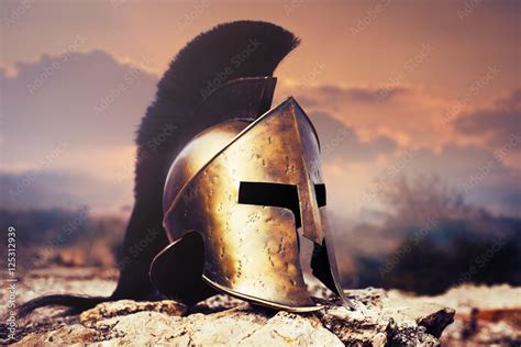 Spartan helmet on ruins with sunset sky. Stock Photo | Adobe Stock