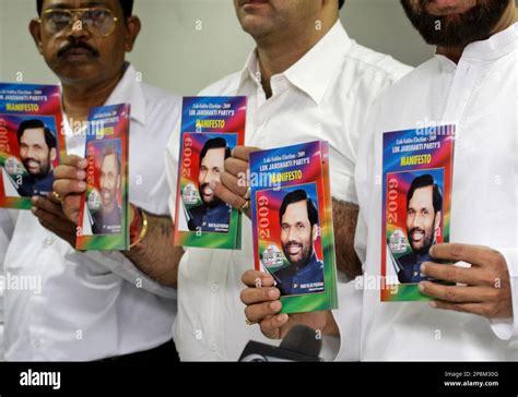 Indian Lok Janshakti Party workers pose with their party's manifesto in ...