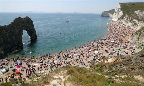 People enjoying the good weather on the beach at Durdle Door, near ...