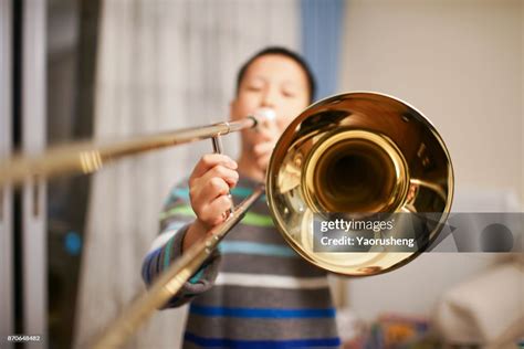 Portrait Of A Boy Playing The Trombone High-Res Stock Photo - Getty Images