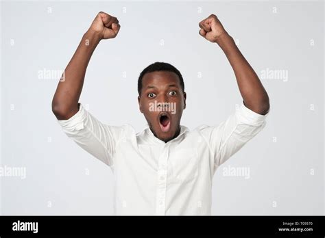 Winner celebrates. Excited african man with happy facial expression ...