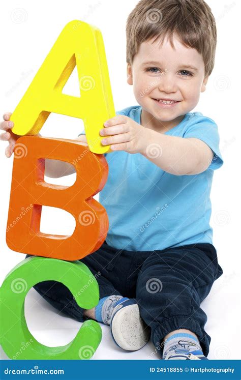 Boy with alphabet stock image. Image of playing, happy - 24518855