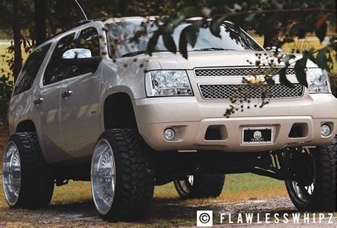 Jacked Up Chevy Tahoe on a Grass Field