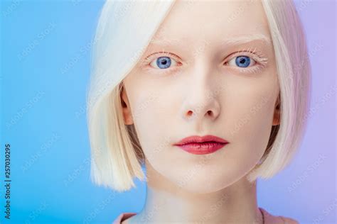 awesome beautiful albino with makeup and blue eyes looking at the ...