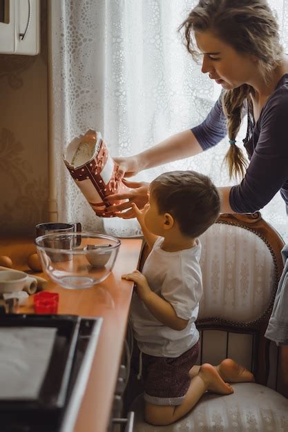 Free Photo | Little boy in the kitchen helps mom to cook. the child is ...