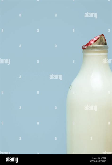 Milk bottle on pale blue background Stock Photo - Alamy