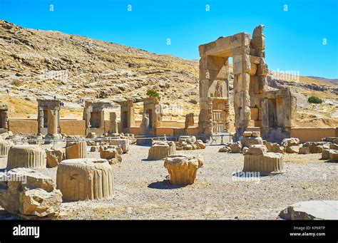 The stone ruins of Hundred Columns Hall of Persepolis with the rocky ...