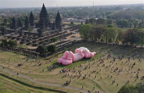 Kaws Exhibits a Giant Reclining Rabbit Doll at Prambanan Temple ...