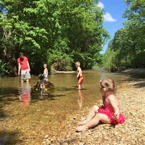 big family playing in the creek - Raising Roberts