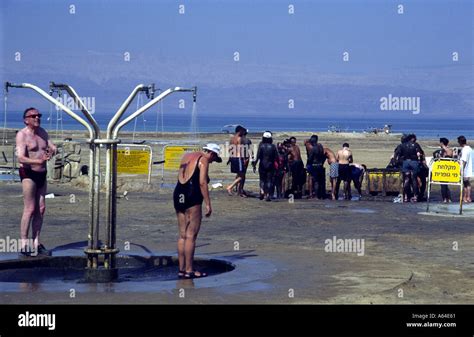 Israel Dead Sea area health resort people showering off Dead Sea mud ...