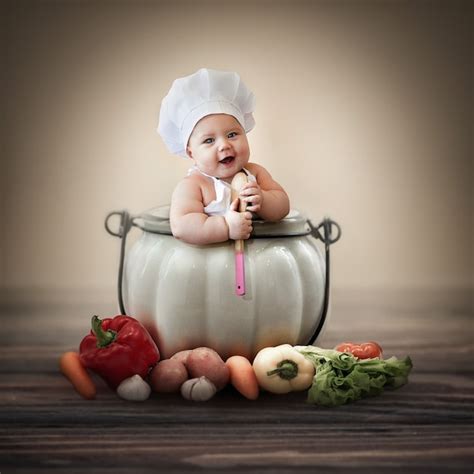 Premium Photo | Little happy baby chef sitting in a saucepan