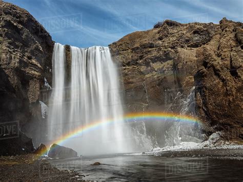 Rainbow over Skogafoss waterfall, iceland - Stock Photo - Dissolve