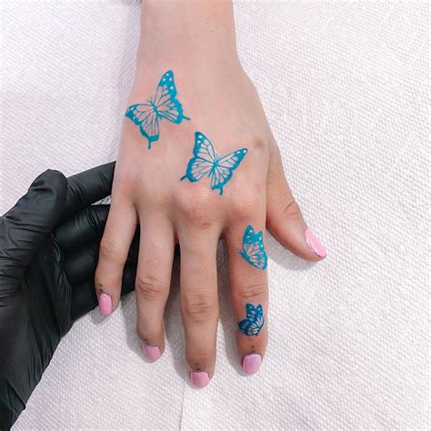 Blue Butterfly Tattoo By whoaakat (Twitter) | Butterfly hand tattoo ...