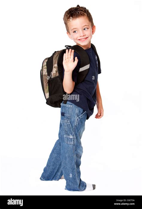 Young boy with backpack waving goodbye Stock Photo - Alamy