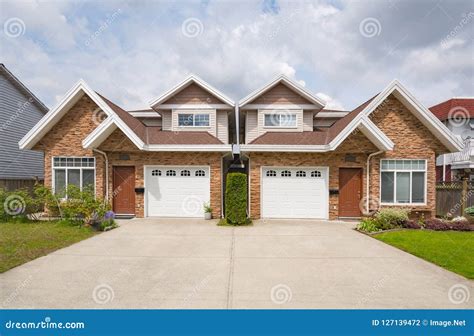 Residential Duplex Building with Concrete Drive Way and Green Lawns in ...