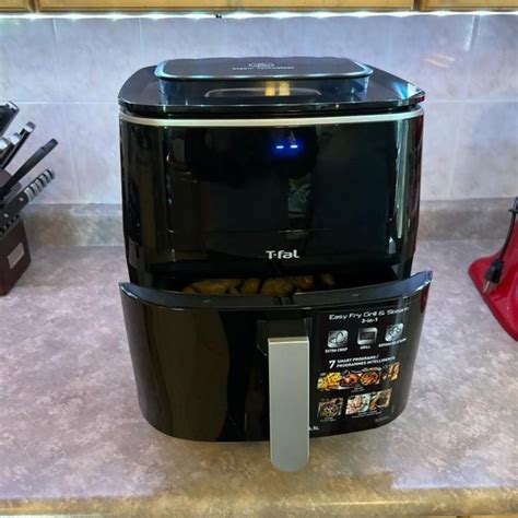 a black and silver toaster sitting on top of a counter