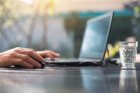 Premium Photo | Working at a laptop in the outdoor courtyard men's ...