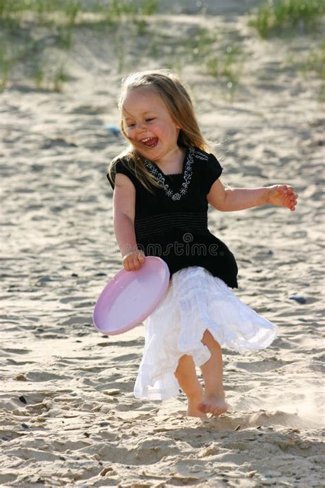 Playing frisbee on a beach stock photo. Image of happy - 1963426