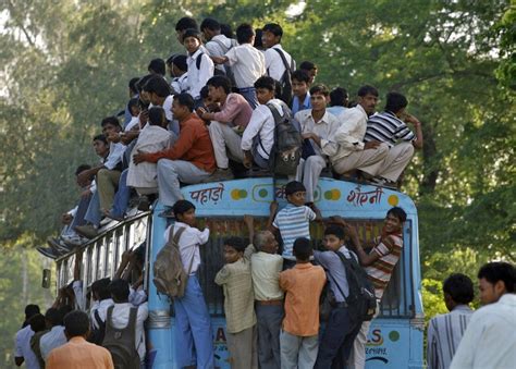 Commuters including school boys travel on a crowded passenger bus. It ...