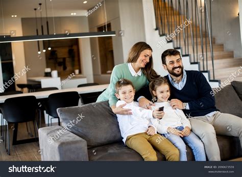 Smiling Young Family Watching Tv Together Stock Photo 2090673559 ...