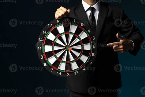 businessman in suit holding dart on dark background 5884667 Stock Photo ...