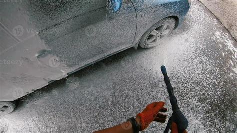 Young man covered soap suds on his car 11363819 Stock Photo at Vecteezy