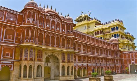 the building is made of red bricks and has many arches on each side ...