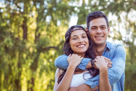 Cute couple smiling in the park — Stock Photo © Wavebreakmedia #76432935