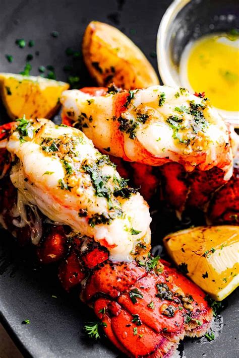 Fancy baked lobster tails served with a garlic butter sauce is the ...