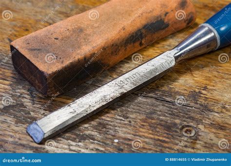 Old Chisel and Stone for Sharpening on a Table in a Workshop Stock ...