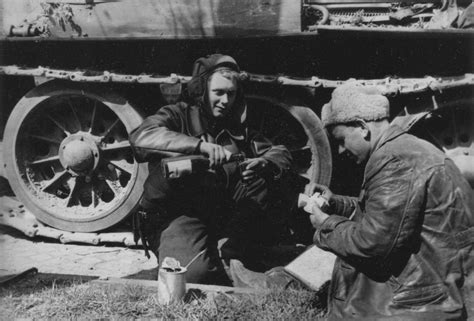 Soviet tank crews are drink next to their T-34 tank. No date and time ...