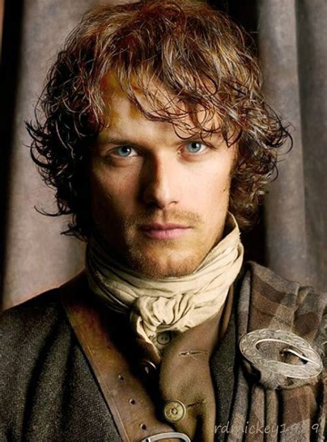 a man with curly hair and blue eyes wearing a brown coat, white shirt ...