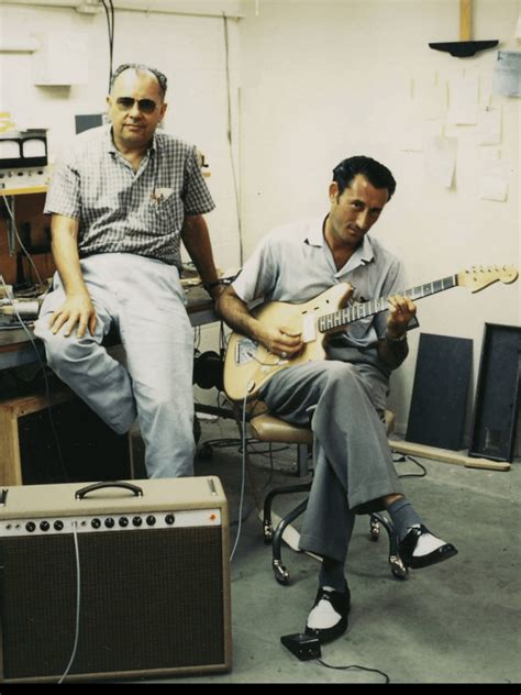 Luther Perkins, guitarist for Johnny Cash, playing a Jazzmaster next to ...