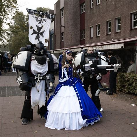 two cosplays dressed in costumes are walking down the street while ...