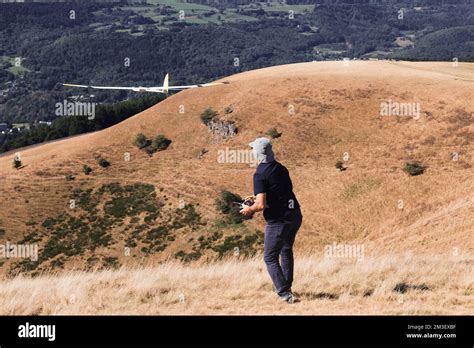 A closeup of a man launches a radio-controlled model glider during an ...