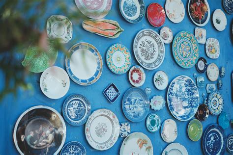 Decorative ceramic plates on blue wall · Free Stock Photo